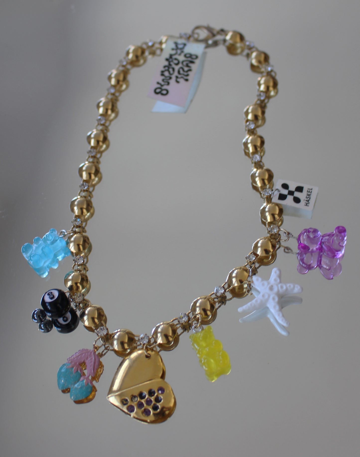 A AGoLD CHARM BACK NECKLACE