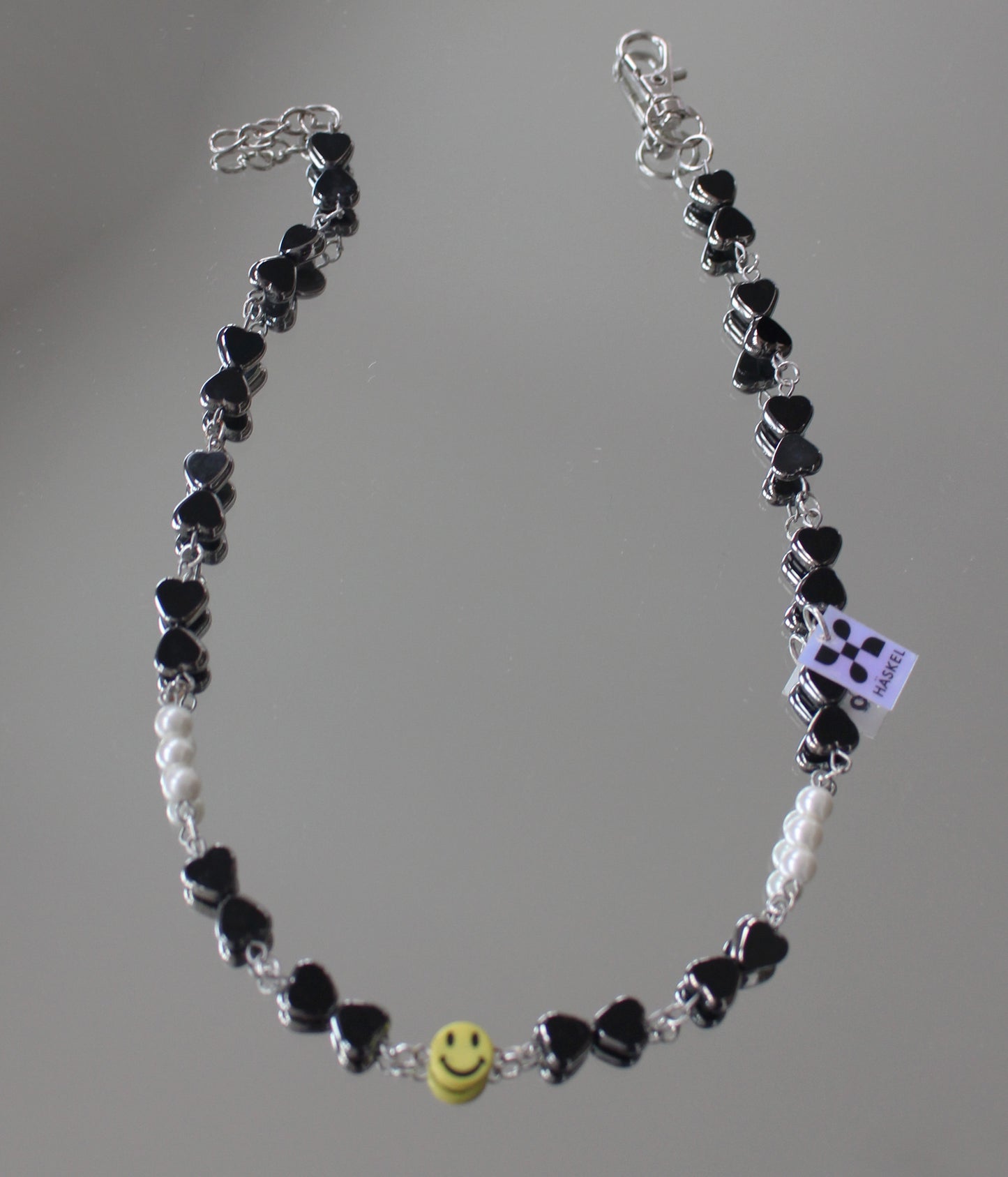 A  ASMILEY IN BLACK GLASS DRESSED